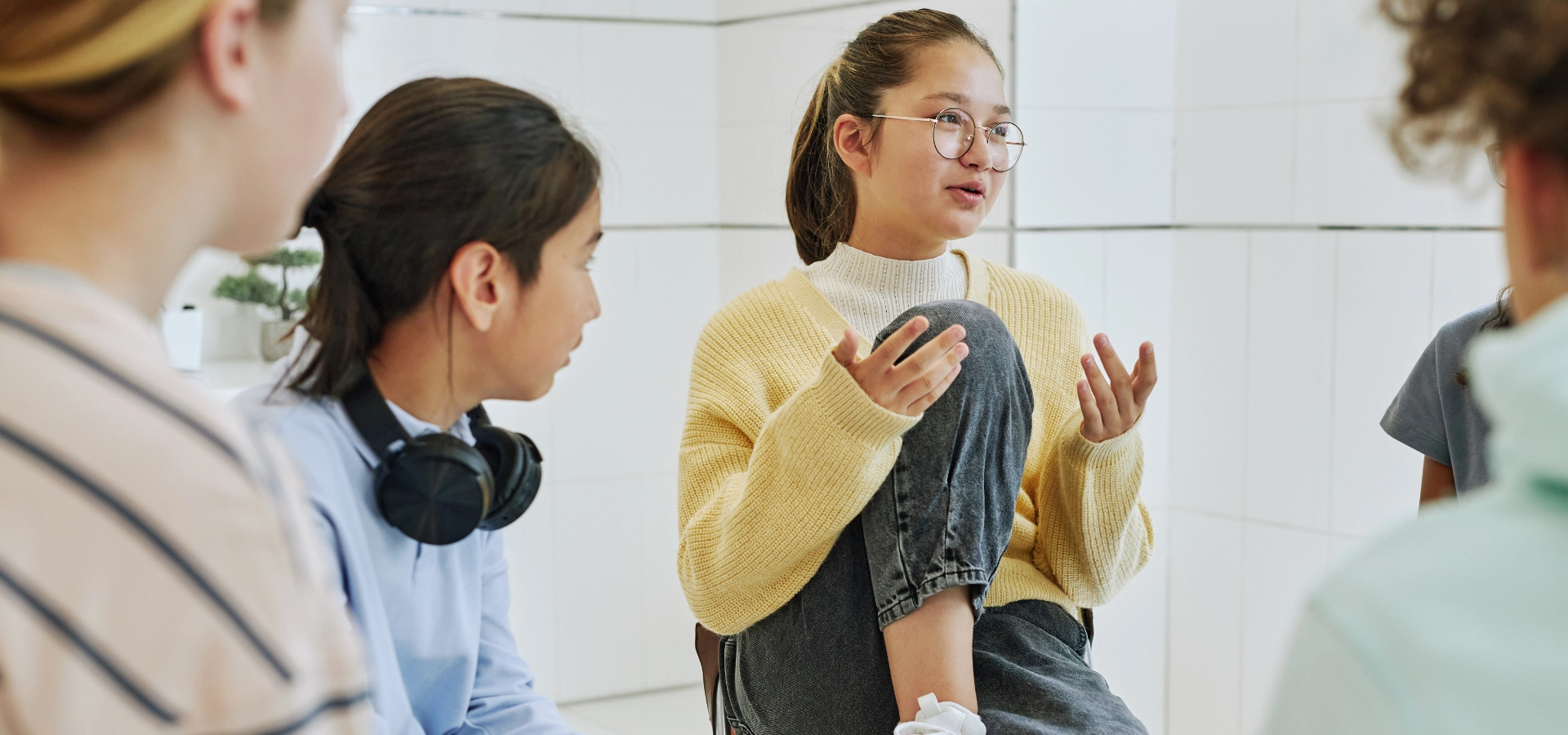 young woman talking to a group of peers